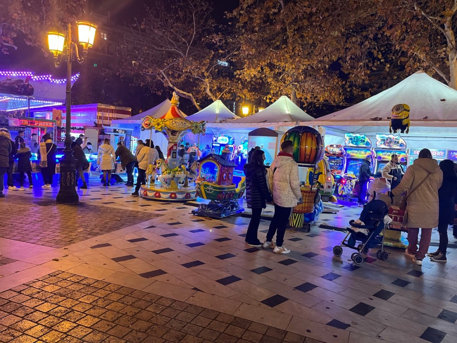 Λευκές τέντες με arcade μηχανήματα και καρουζέλ στην πλατεία Αριστοτέλους Θεσσαλονίκης το βράδυ